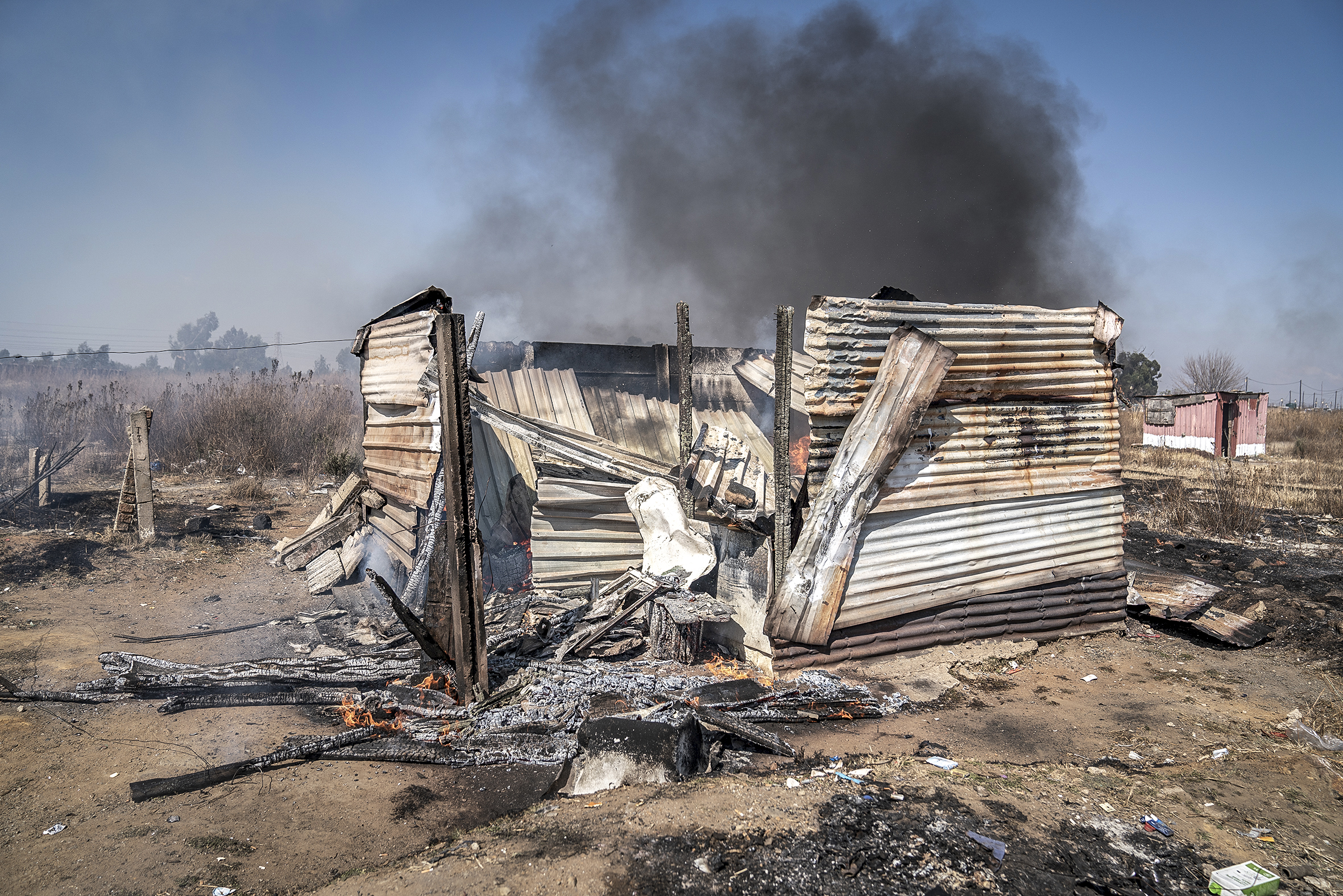 The smoldering remains of an alleged zama zama dwelling.