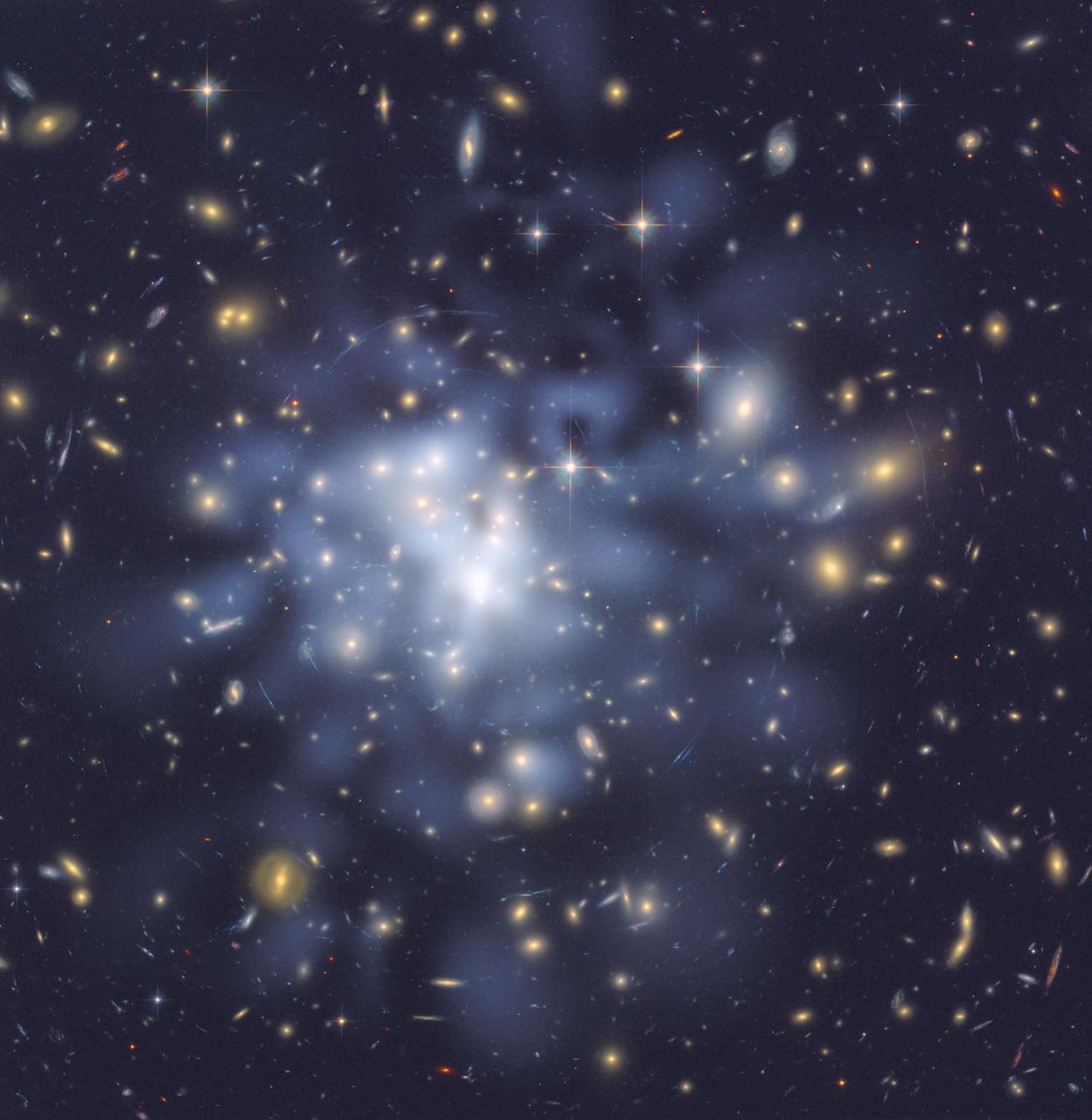 This Hubble Space Telescope composite image shows a ghostly "ring" of dark matter in the galaxy cluster
