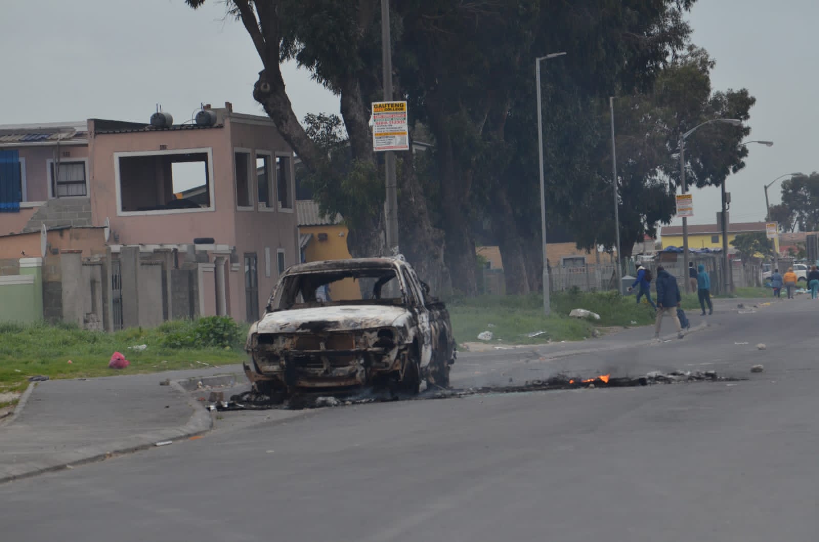 The remains of a burnt-out car following taxi protests