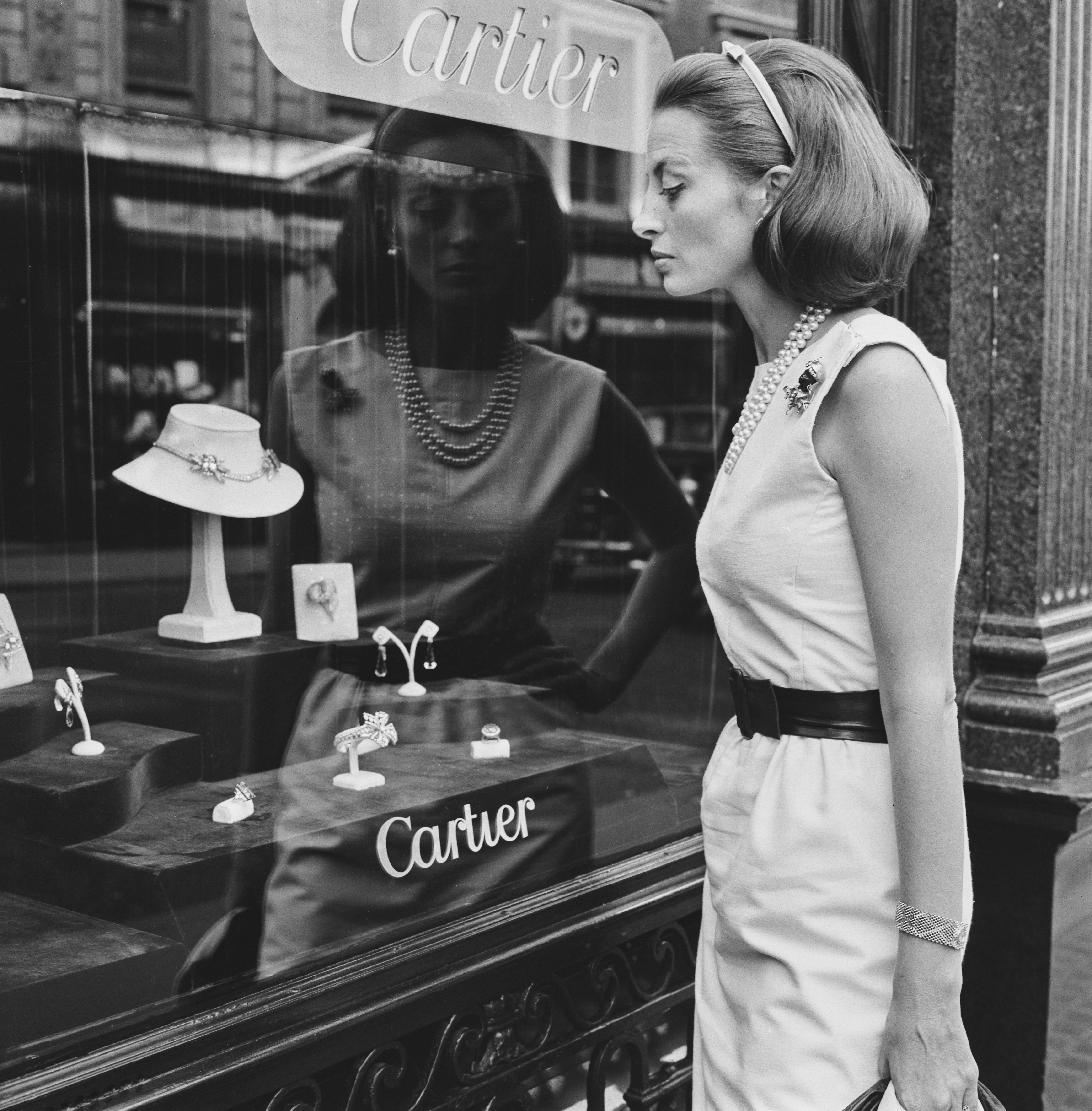 French actress Capucine (1928 - 1990) window shopping at the Cartier jewellery store on Old Bond Street in London, UK, 10th August 1964. (Photo by Evening Standard/Hulton Archive/Getty Images)
