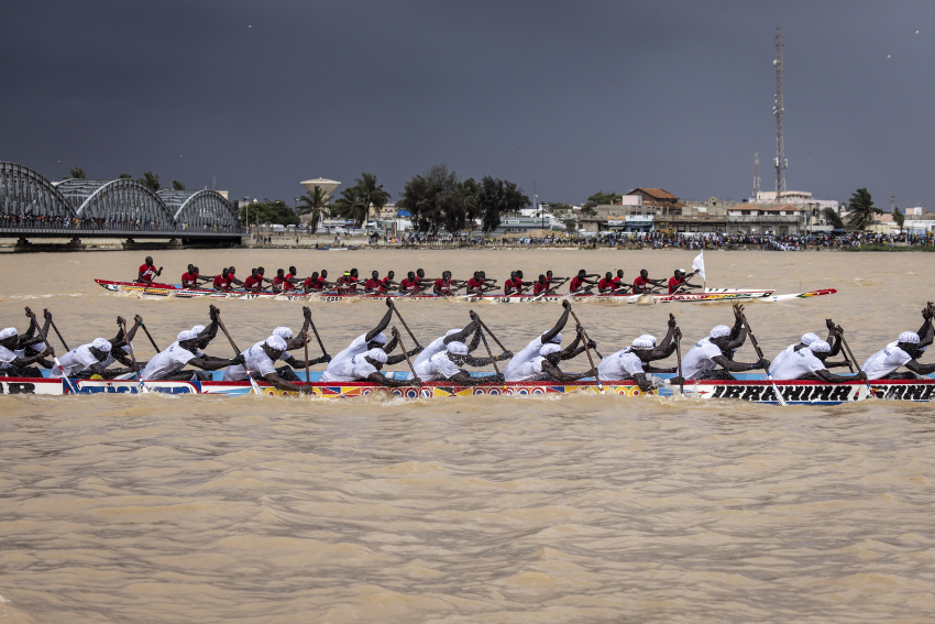 Two pirogue teams race each other along the Senegal River in Saint-Louis on 23 July 2022. Each neighbourhood puts forward multiple teams to compete in the event. Said to date back 200 years, traditional Senegalese pirogue racing is an extremely popular sport. Crowds descend to the banks of the Senegal River in Saint-Louis to cheer on teams from along the Senegal coast. Starting in the early hours of the morning, supporters gather to watch the unveiling of each pirogue, which is freshly painted and blessed by each team’s religious leader, their marabout. The boats are then pushed into the river with cheers from the crowds. © John Wessels, South Africa, Shortlist, Professional competition, Sport, Sony World Photography Awards 2023