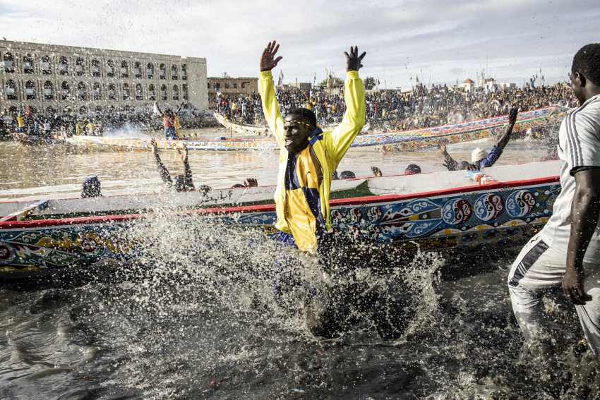 Supporters cheer as their team’s pirogue is unveiled in the fishing village of Guet N’Dar in Saint-Louis on 23 July 2022. Said to date back 200 years, traditional Senegalese pirogue racing is an extremely popular sport. Crowds descend to the banks of the Senegal River in Saint-Louis to cheer on teams from along the Senegal coast. Starting in the early hours of the morning, supporters gather to watch the unveiling of each pirogue, which is freshly painted and blessed by each team’s religious leader, their marabout. The boats are then pushed into the river with cheers from the crowds. © John Wessels, South Africa, Shortlist, Professional competition, Sport, Sony World Photography Awards 2023 