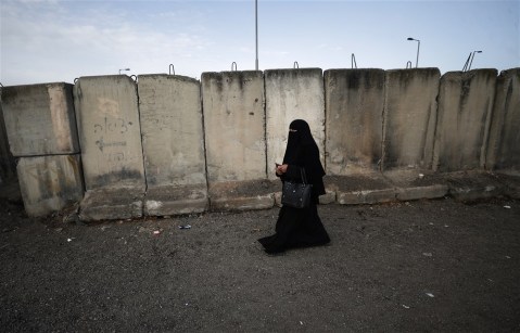 A Palestinian woman waiting to cross Qalandia checkpoint between West Bank and Jerusalem, to attend the first Friday prayer of the Muslim holy month of Ramadan in Al Aqsa Mosque in Jerusalem’s old city, 24 March 2023. Women of all ages, children up to the age of 12, and men older than 55 from the West Bank will be allowed to enter Jerusalem to attend Friday prayers at Al-Aqsa Mosque without existing permissions, Israeli military announced.  EPA-EFE/ATEF SAFADI