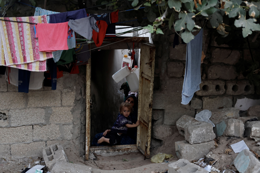 Khadija Kuhail (30), holds her son, Mohanad (1), in the doorway of their family home at Sheikh Shaban cemetery. Visitors have to climb three steps to get into the sparsely furnished house, where they encounter a strong smell. Kamilia Kuhail calls it ‘the smell of death’.While the authorities grapple with a growing demand for new housing in the densely populated Gaza Strip, a battle for space is pitting the living against the dead, as homeless squatters settle in the area’s cemeteries, The pressure on space in the cemeteries reflects a mounting demographic crisis in Gaza, where the population is set to more than double within the next 30 years. Land is running out and competition for scarce Gaza real estate is understandably fierce, with an ever-increasing demand for both housing and farming land to help feed the growing population. Now, even the dead are affected, as their resting places are pressured by squatters and the relentless realities of a growing population with nowhere else to go. © Mohammed Salem, Palestinian Territory, Occupied, Finalist, Professional competition, Documentary Projects, Sony World Photography Awards 2023