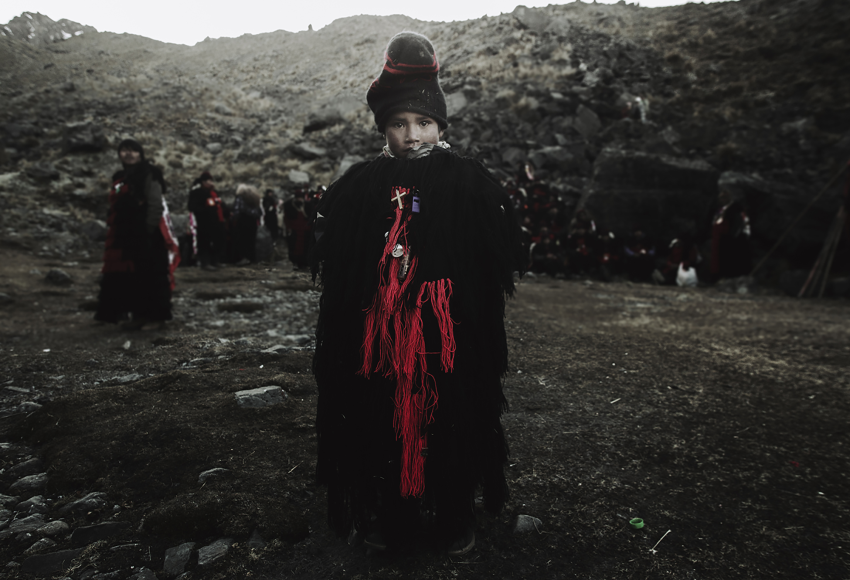 'Pablito'. A child representative of the Q’ero nation accompanies the Paucartambo nation. These images were captured during a visit to the Andean religious pilgrimage that brings together the Andean nations of the Peruvian region of Cusco. On the slopes of the snow-capped Sinaq’ara mountain, at 4,700 metres (15,400 feet) above sea level, in the district of Ocongate, the people gather to worship the religious image of the Lord of Qoyllur Rit’i and perform rituals to connect with nature and its energy. © Frederick Olivera Gonzales, Peru, Shortlist, Professional competition, Documentary Projects, Sony World Photography Awards 2023