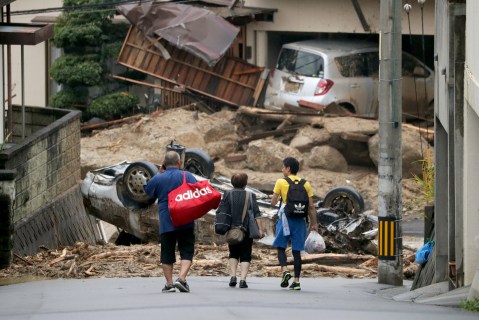 Japan rescuers go house to house as flood toll hits 141